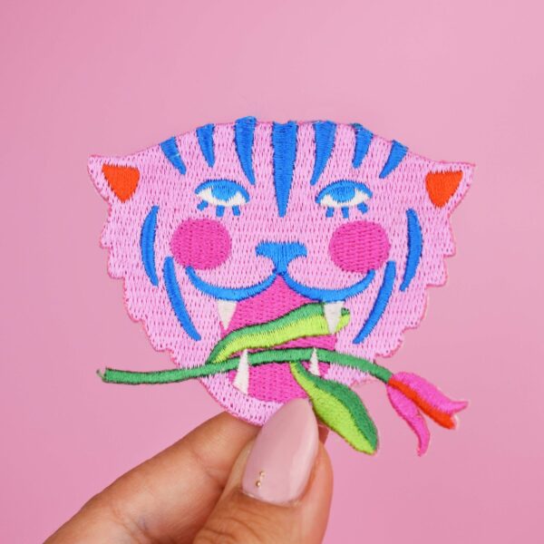 Broderet strygemærke med tiger og blomst i blå og rosa farver til reparation og dekoration af tøj og tasker.